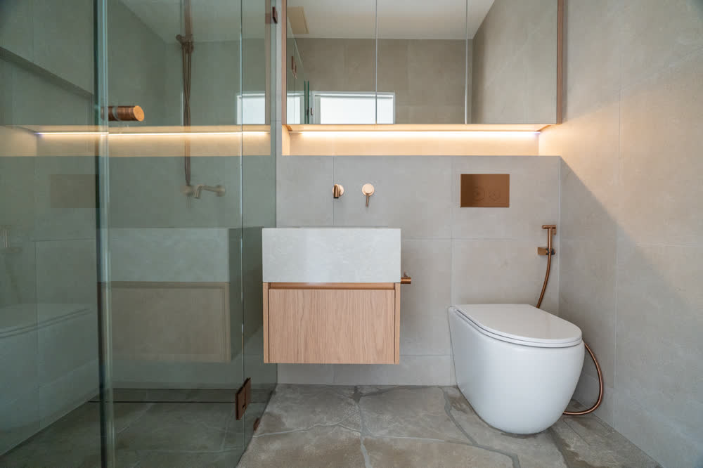 Second bathroom at Glenorie — glass walk-in shower, floating timber vanity with stone basin, wall-hung toilet and lit shower niche
