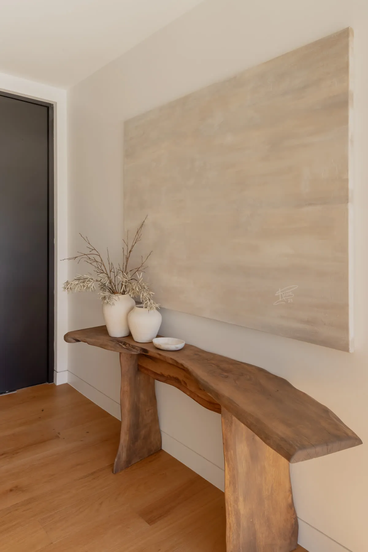 The entry at Glenorie — organic timber console against textured render