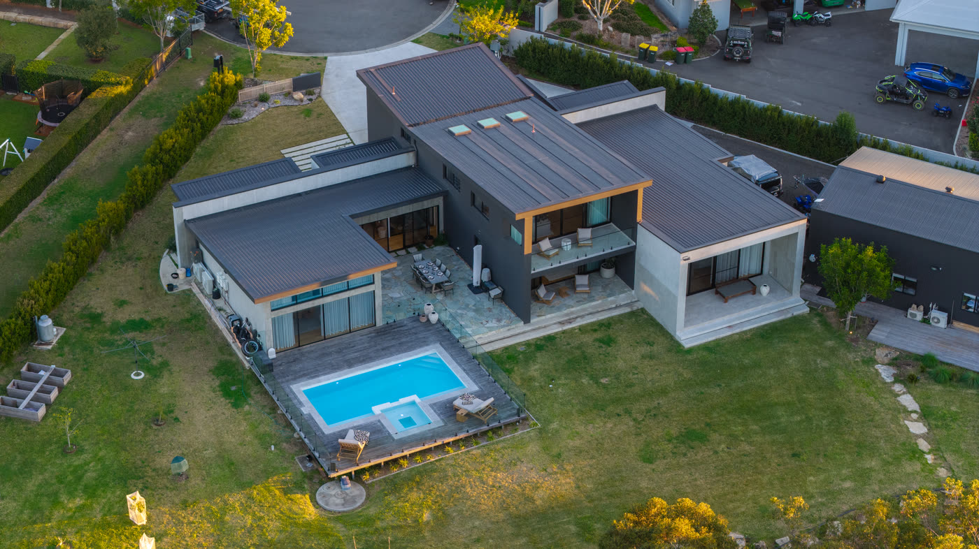 Rear of the Glenorie house showing the pool, spa, timber deck and covered terrace